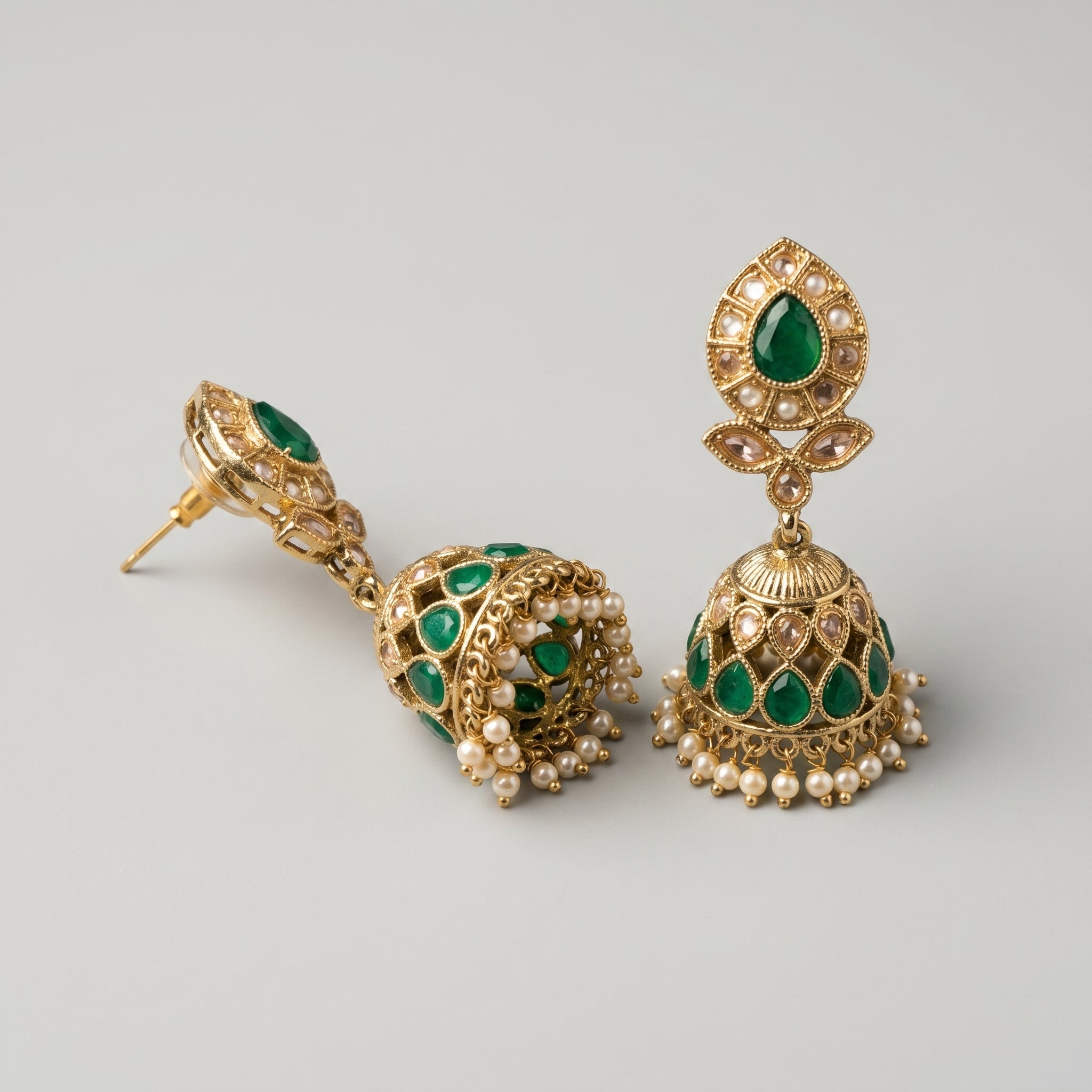 Panna Jhumka Earrings detail showing emerald-green teardrop stud, granulated bell dome, and seed-pearl ghungroo fringe