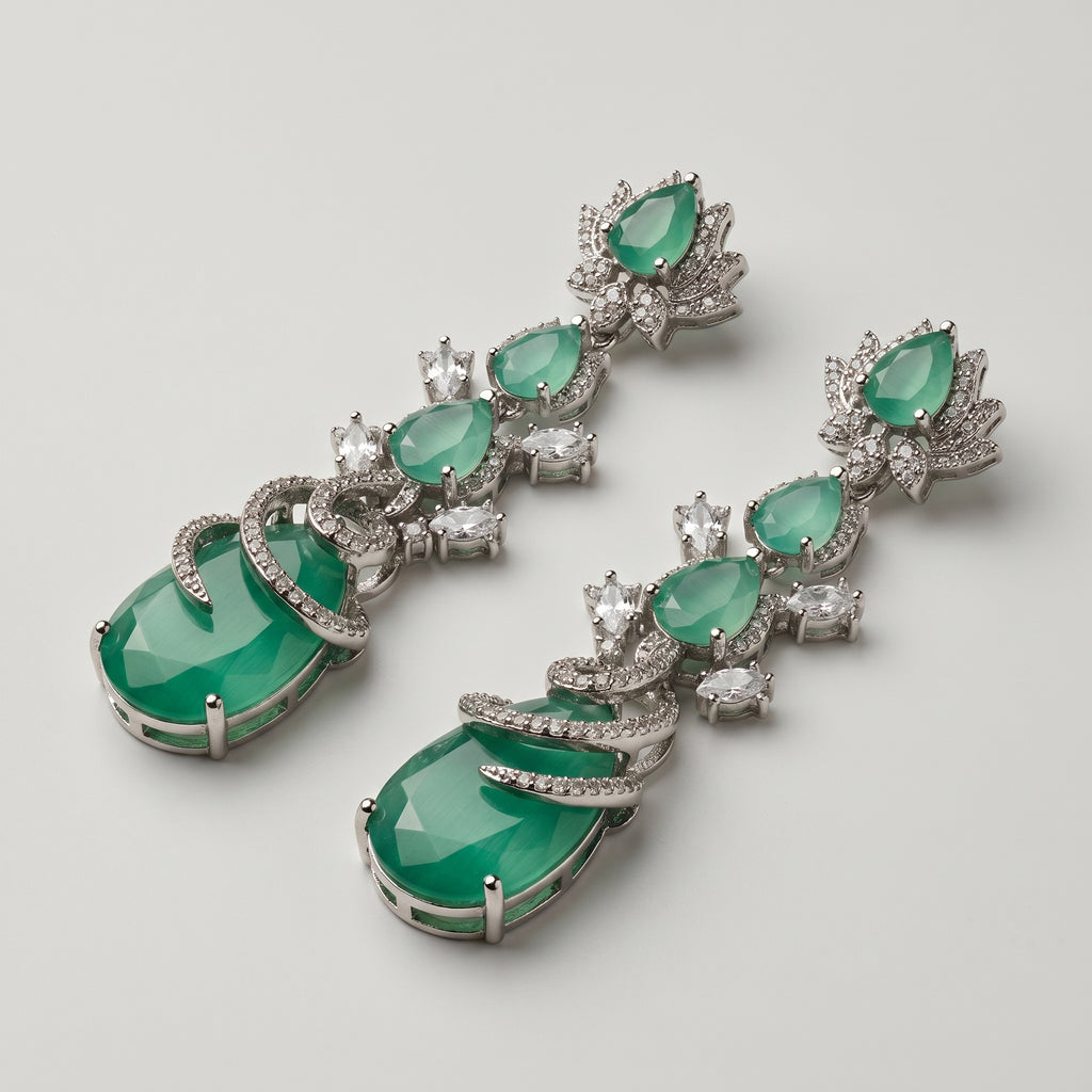 Sia Vine Earrings detail showing lotus floral stud, chatoyant green pear stones, and spiral pavé-wrapped bottom drop