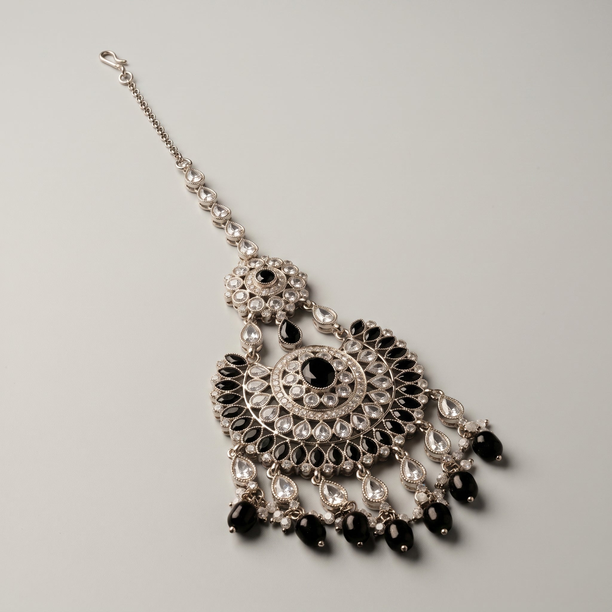 Onyx Pearl Tikka detail showing black oval borders and pearl-cluster fringe along crescent base