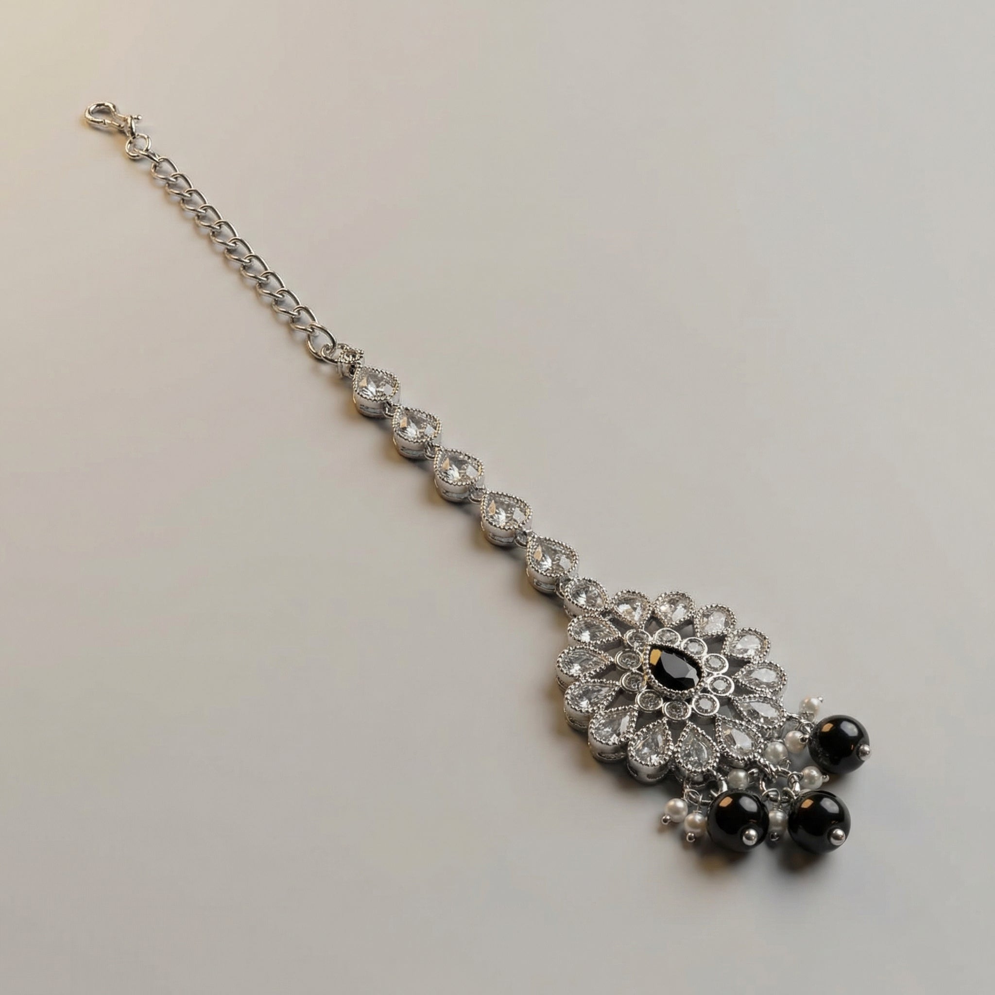 Sia Noir Tikka detail showing crystal mandala pendant, black teardrop center, and pearl-trimmed bead fringe