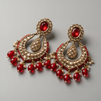 Jadau Ruby Earrings detail showing red oval stud kundan grid crescent and red bead pearl drops
