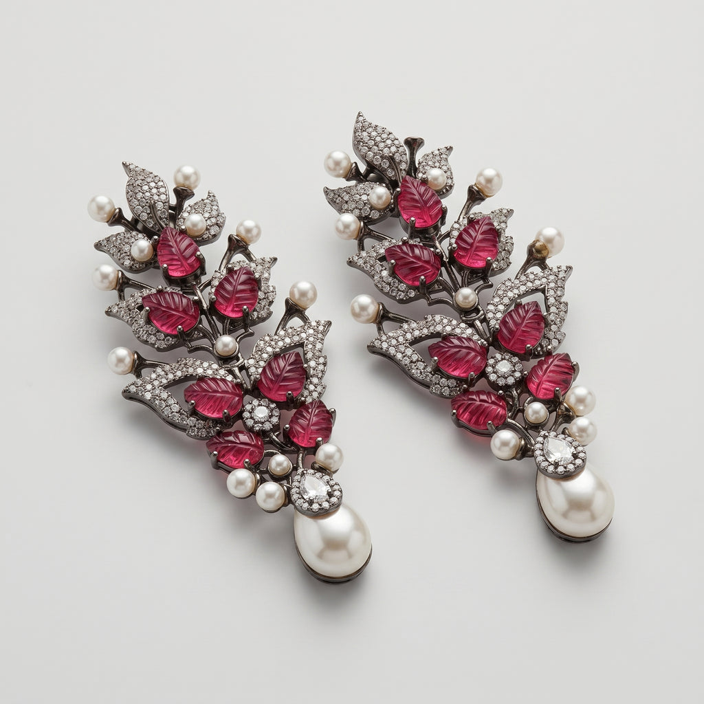 Rani Ruby Earrings detail showing carved ruby-red leaves, clear crystal foliage, and teardrop pearl drop