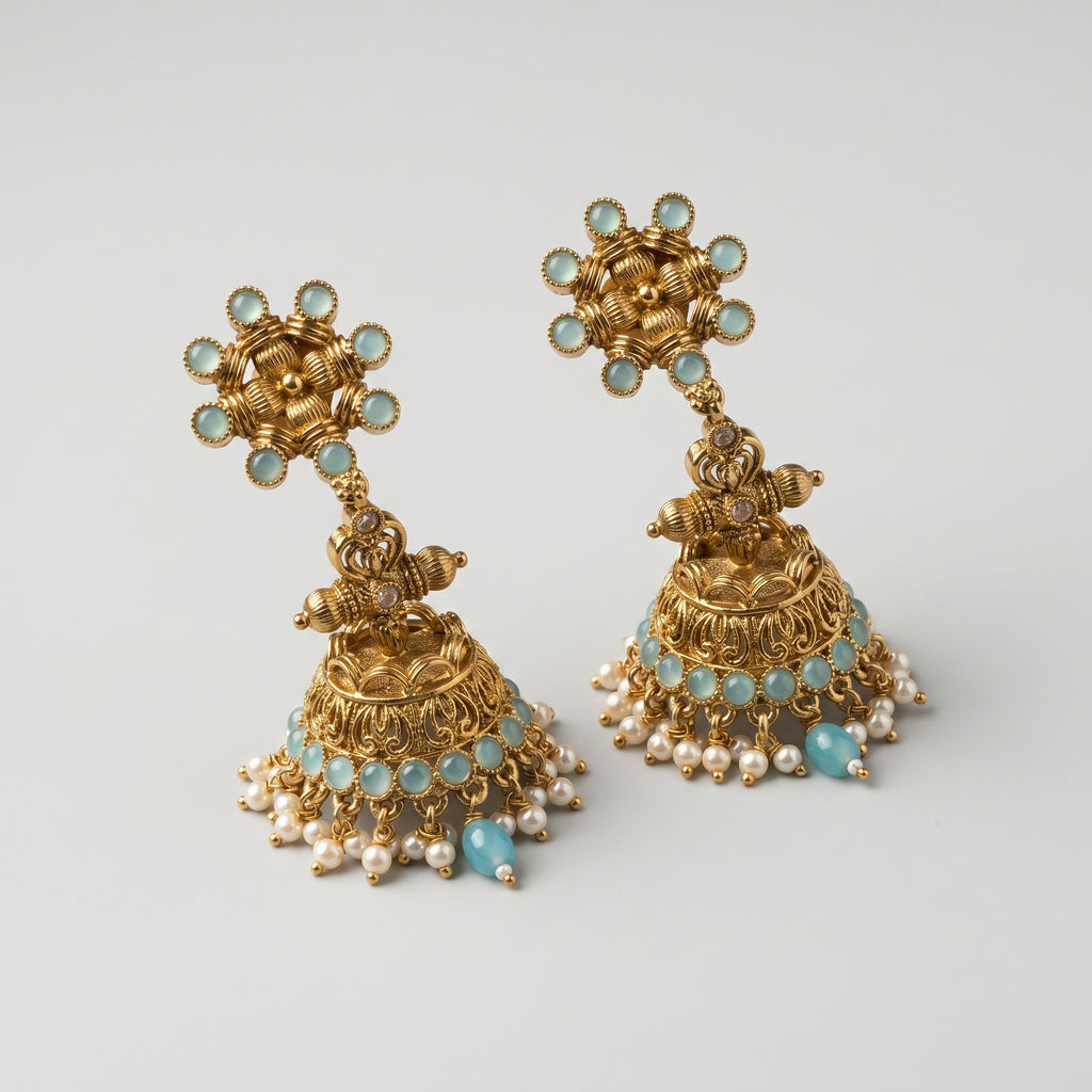 Tara Mint Earrings detail showing sunburst aqua stud, filigree bell, and pearl border