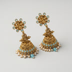 Tara Mint Earrings detail showing sunburst aqua stud, filigree bell, and pearl border