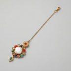 Rangoli Moti Tikka detail showing white center cabochon, colored stone ring, and green drop