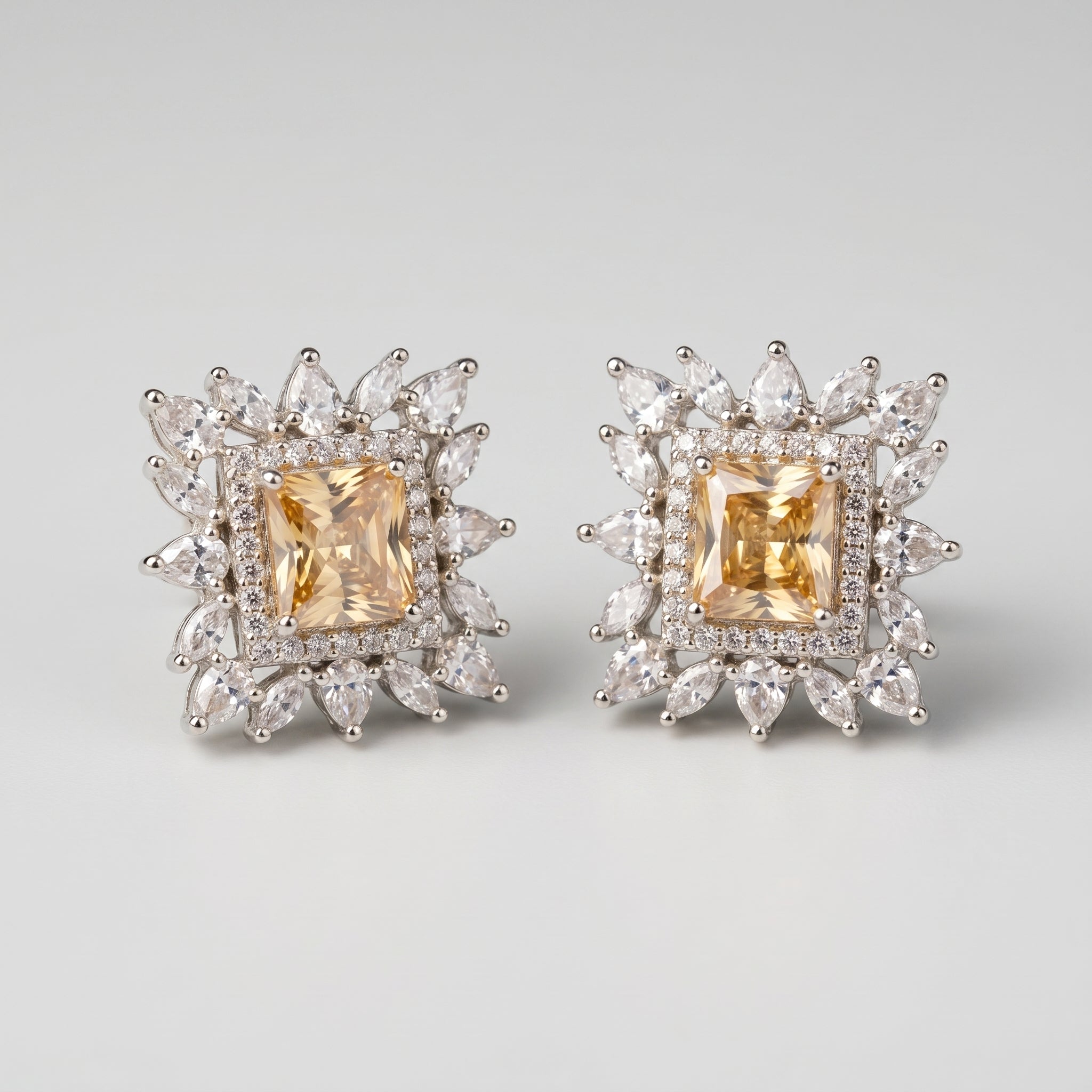 Citrine Square Earrings detail showing yellow emerald-cut center crystal halo and pear sunburst border