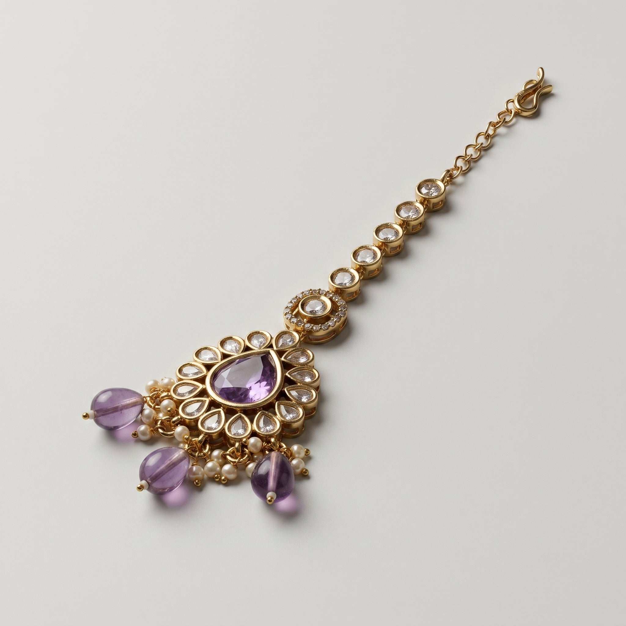 Sia Amethyst Tikka detail showing purple centerpiece and clear crystal stem