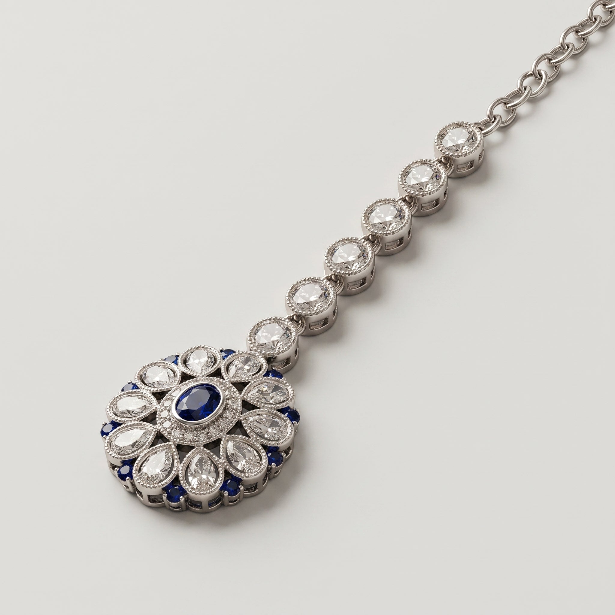 Nilam Bloom Tikka detail showing blue center stone and pear-shaped crystal petals