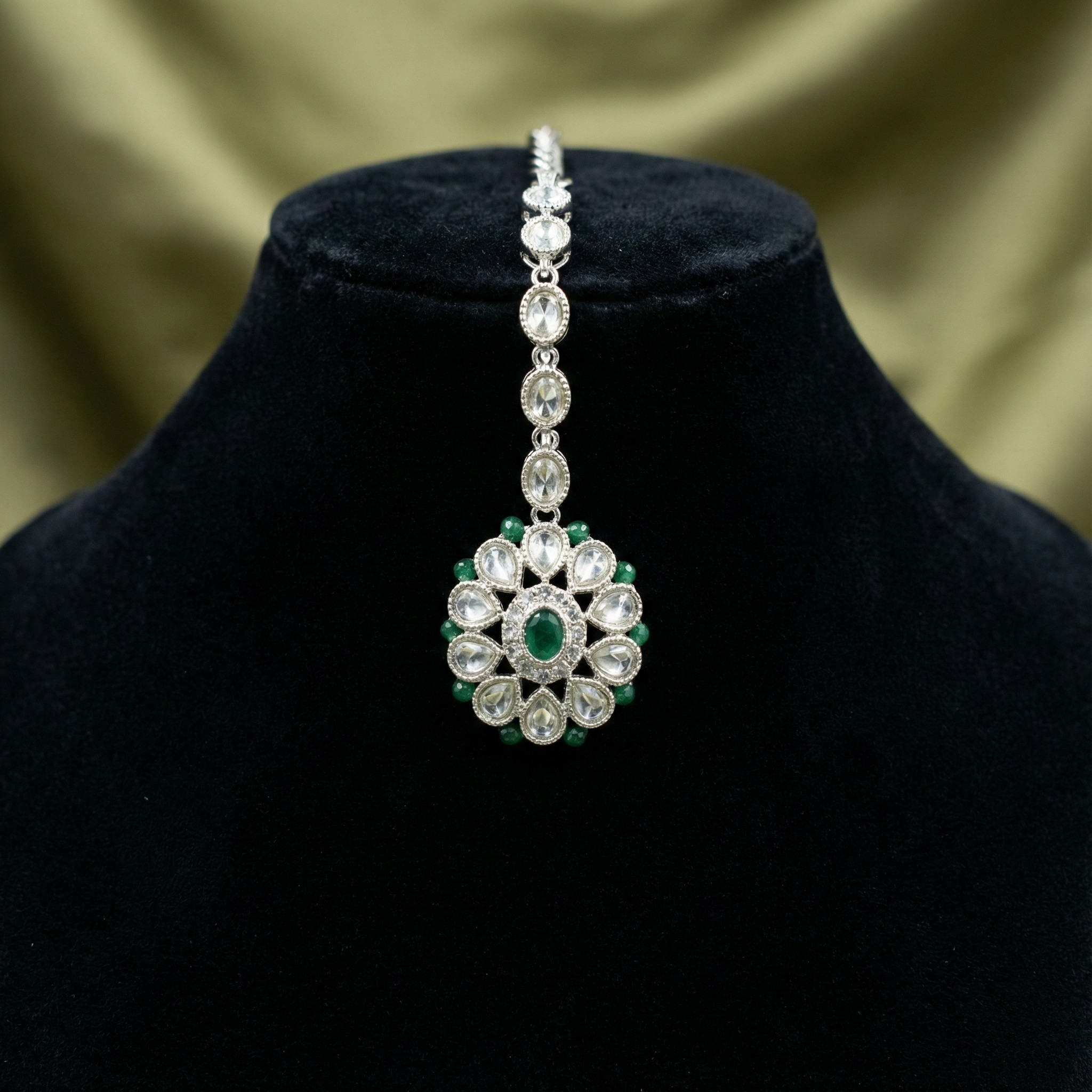 Emerald Axis Tikka detail showing oval emerald center and teardrop crystal petals