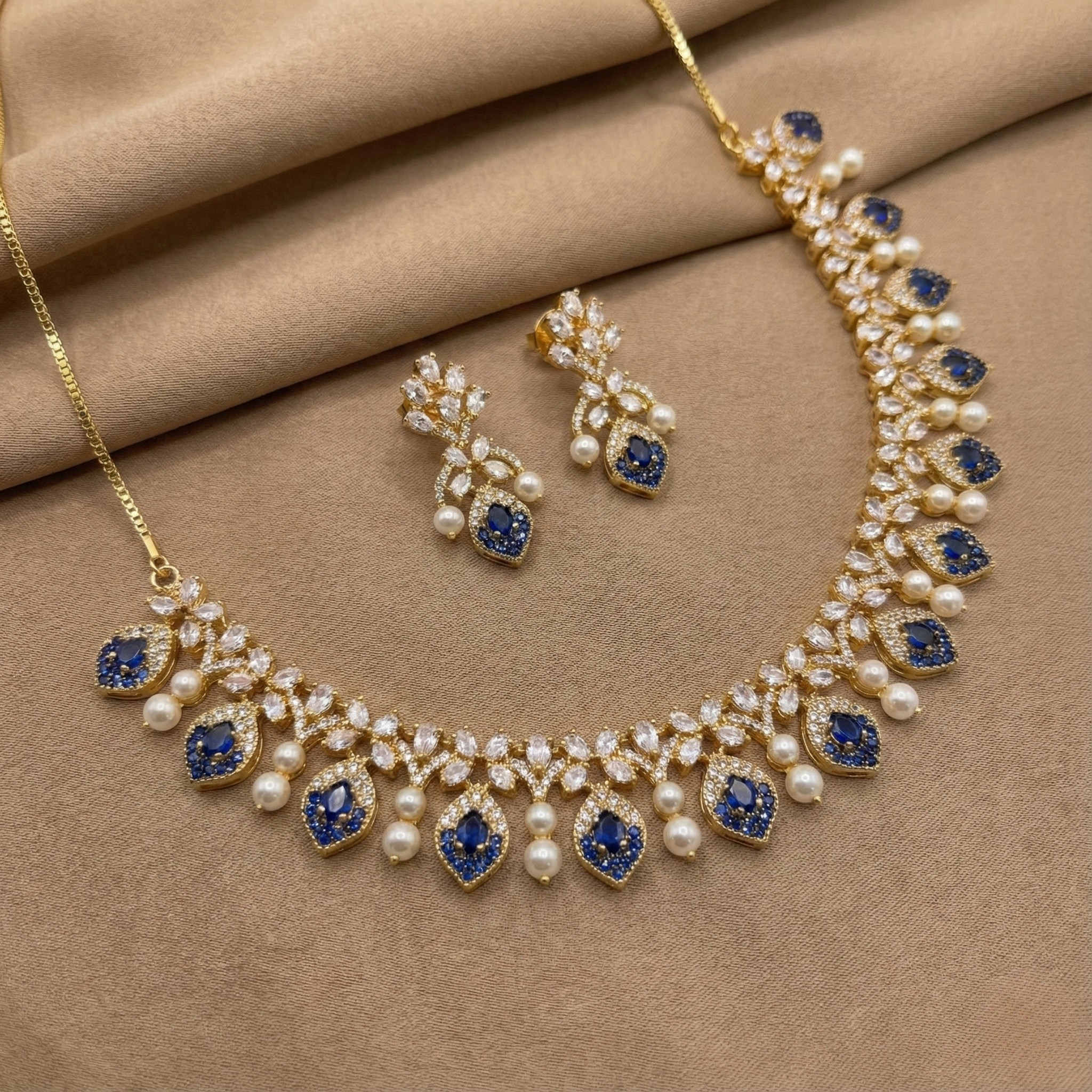 Close-up flatlay of Azure Pearl Glow Statement Set necklace and matching earrings
