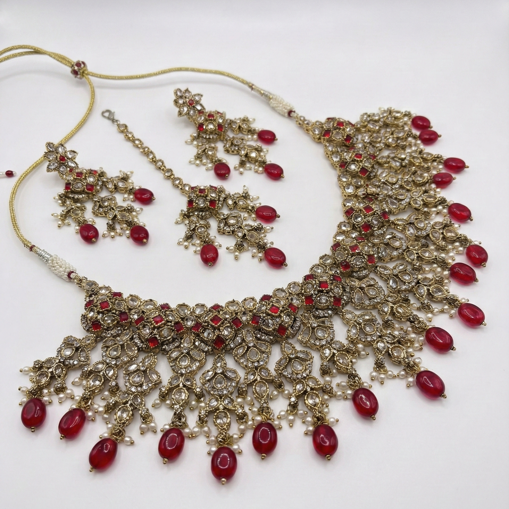 South Asian woman wearing the ruby cascade necklace set — bridal look.