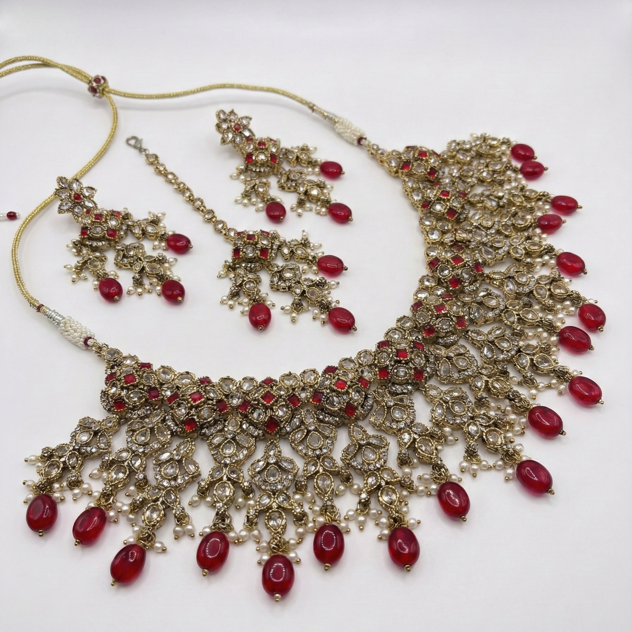 South Asian woman wearing the ruby cascade necklace set — bridal look.