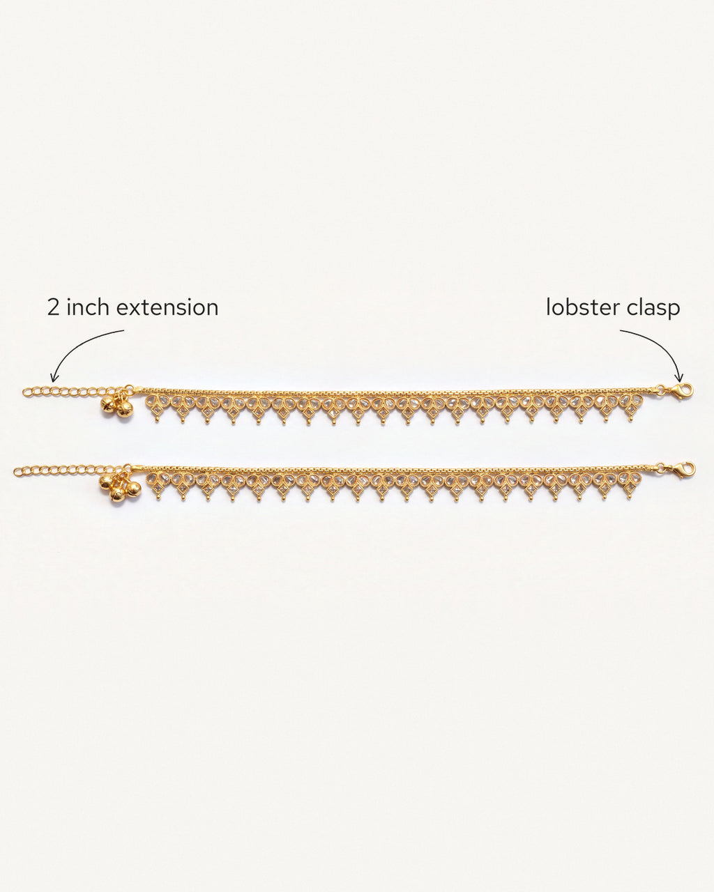Vera gold-tone anklet pair laid flat, showing the lobster clasp and extension chain