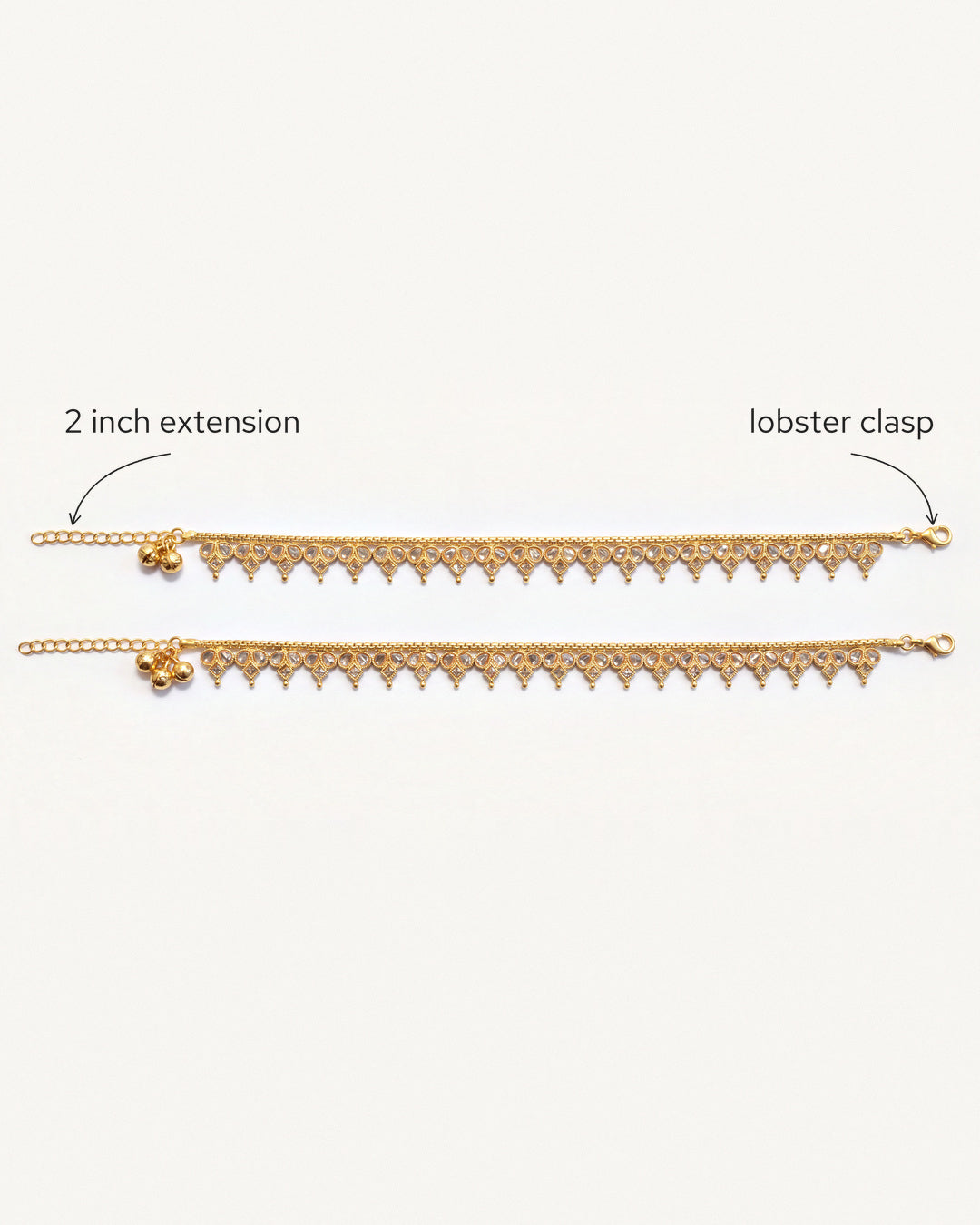 Vera gold-tone anklet pair laid flat, showing the lobster clasp and extension chain
