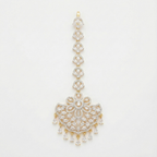 Crescent Lace Tikka gold-tone fan-shaped maang tikka with floral clear-stone center on gray background