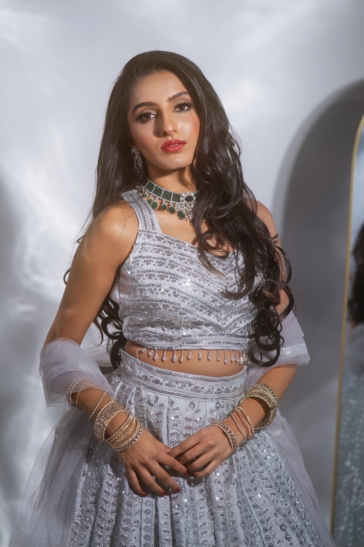 Model wearing Kiian jewelry with a white outfit